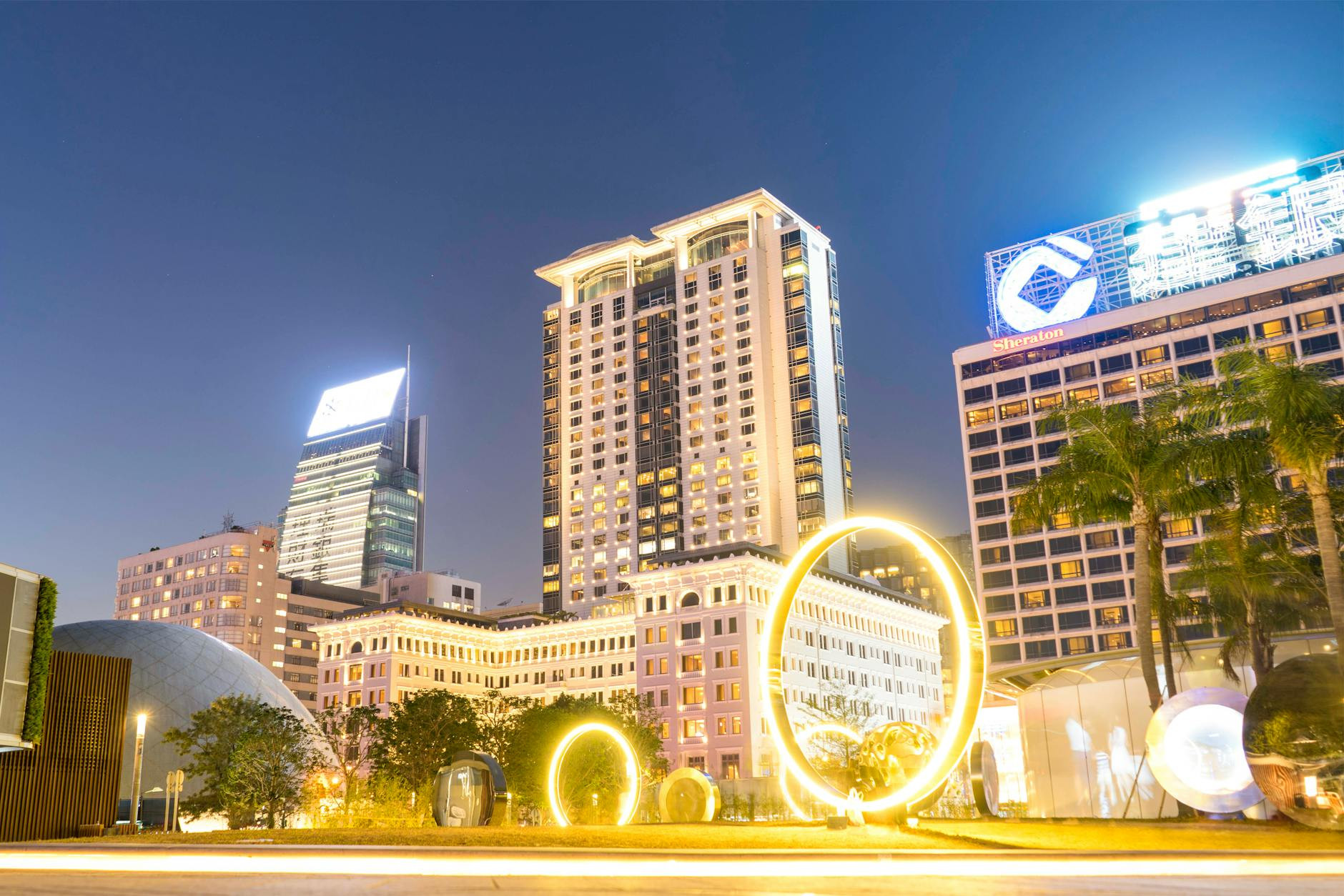 several lighted high rise buildings