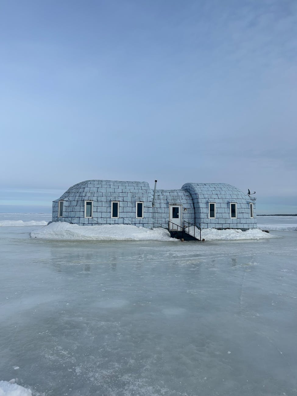 ice fishing house on a frozen lake in winter