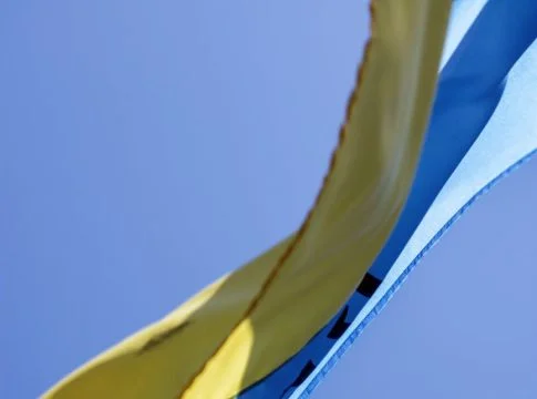 ukrainian flag waving in wind with clear sky in background