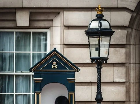 royal guard standing near lamp post