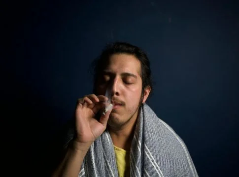 man smoking a cigarette