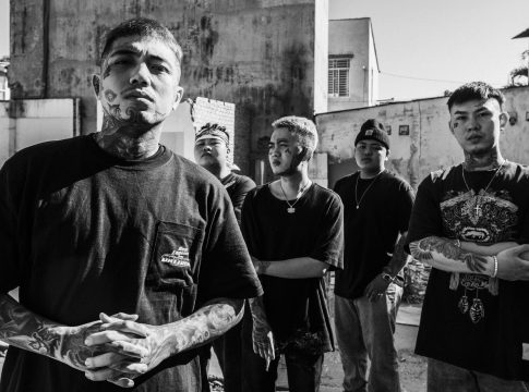 cool asian gang with tattoos on city street